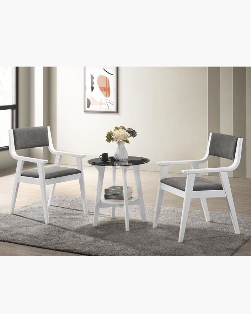 a table with a vase and a pair of chairs
