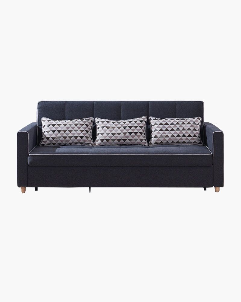 a dark-coloured couch with three pillows on top of it